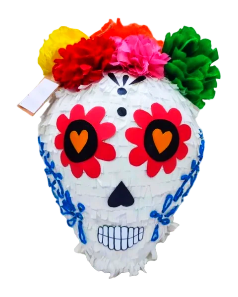Piñata de calavera blanca de flecos, con ojos de flor roja y corazones naranjas, bordados azules en las mejillas y una corona de flores de papel de colores, recortada sobre fondo liso.